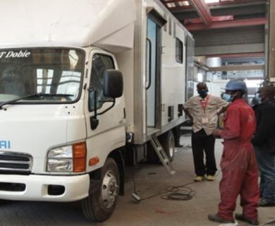 Project team supervising progress of the “Mobile Mortuary” 