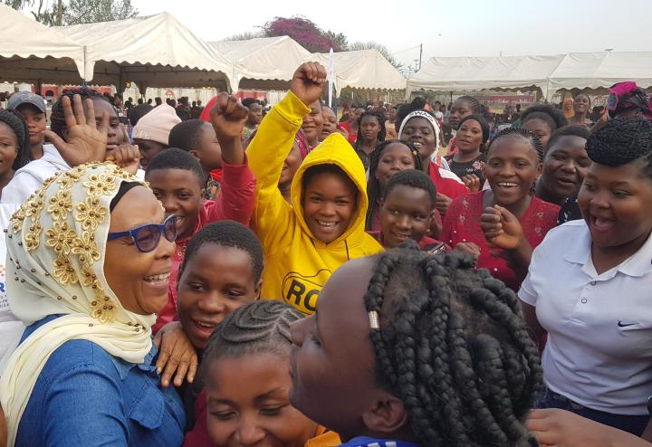 A crowd of women and girls at an outdoor celebration