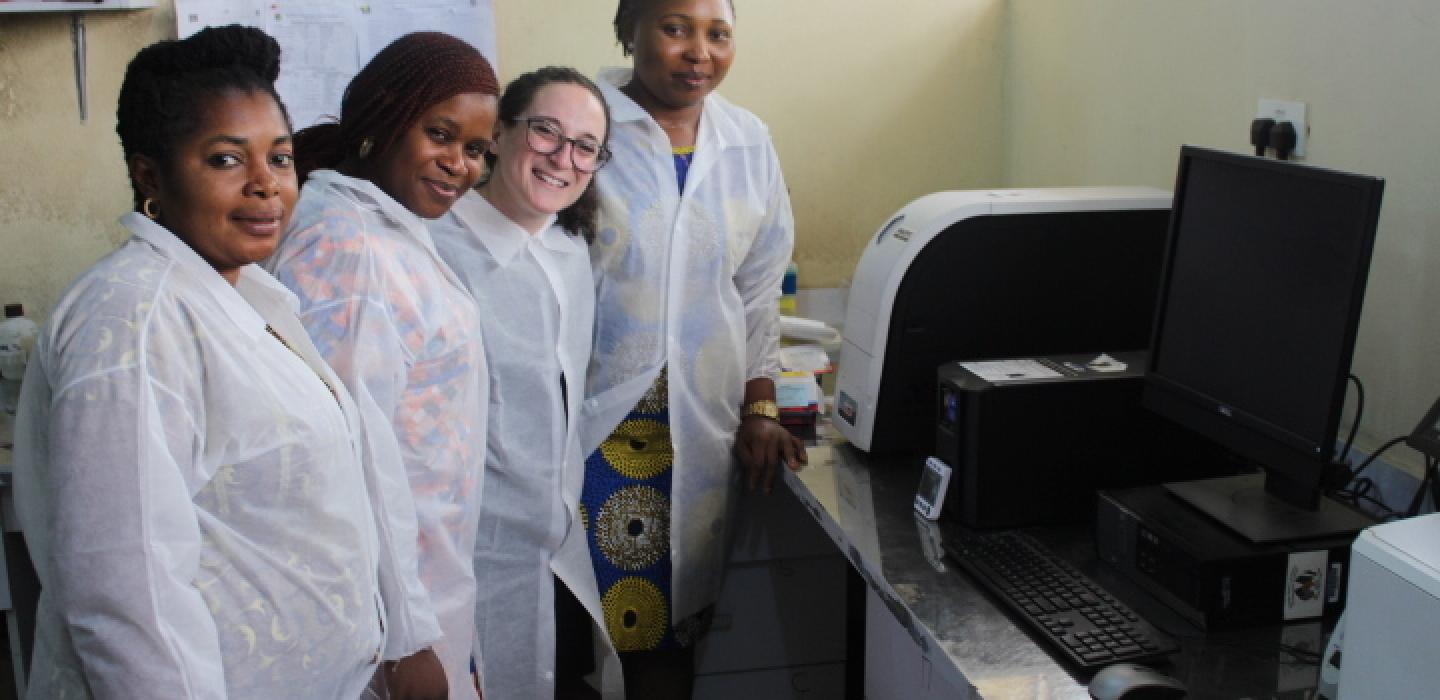 Scientists standing in front of lab equipment