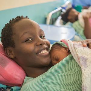 Mother holds her newborn skin-to-skin